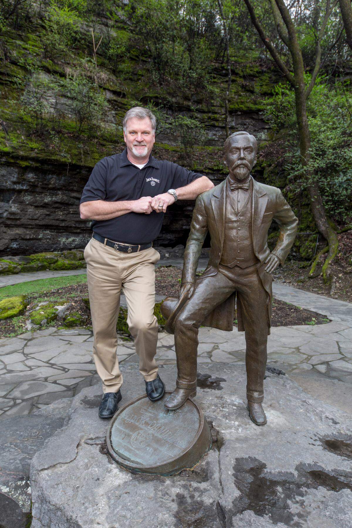 Jeff Arnett, shown with a statue of Jack Daniel at the Lynchburg, Tenn., distillery, is stepping down after 12 years as master distiller, Brown-Forman announced on Thursday.