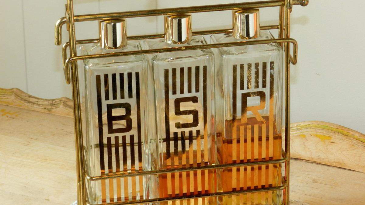 Add a touch of glamor to your party with vintage decanters. This 1970s-era bar caddy features gold-accented bottles for bourbon, scotch and rye, $55 at Etsy.com/shop/thevermontbaglady.