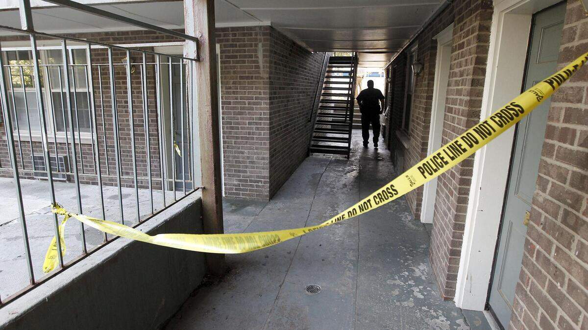 Crime scene tape closed off a hallway at the Dinsmore Apartments n Lexington.