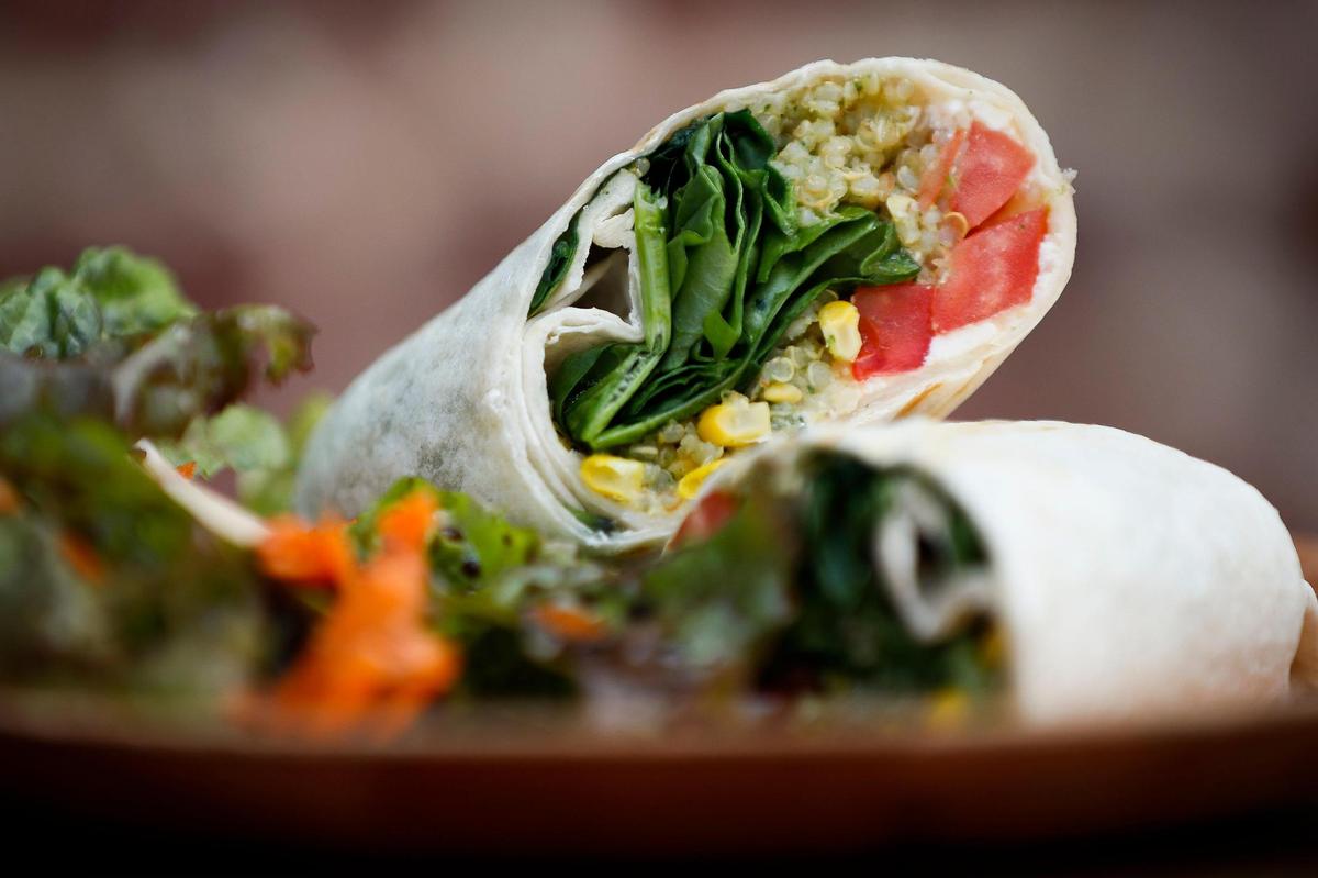 The veggie wrap at Broomwagon is made with hummus, quinoa salad, tomato, spinach, basil and feta.