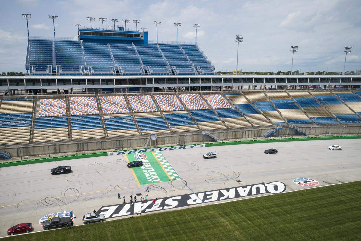 Graduating Gallatin County High School seniors take a “victory lap” around the 1.5 mile track at Kentucky Speedway in Sparta, Saturday, May 23, 2020. Saturday’s lap around the track was part of Gallatin County’s graduation ceremony.