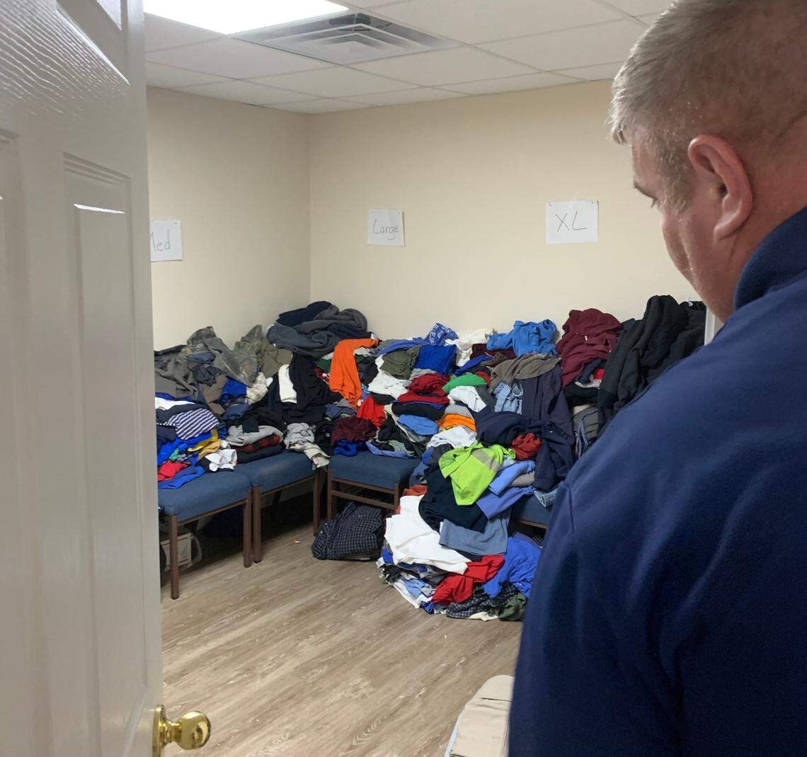 Rep. Chris Fugate, R-Chavies, shows an abundance of donated clothes at a room in Gospel Light, a church converted to a shelter where he is pastor.