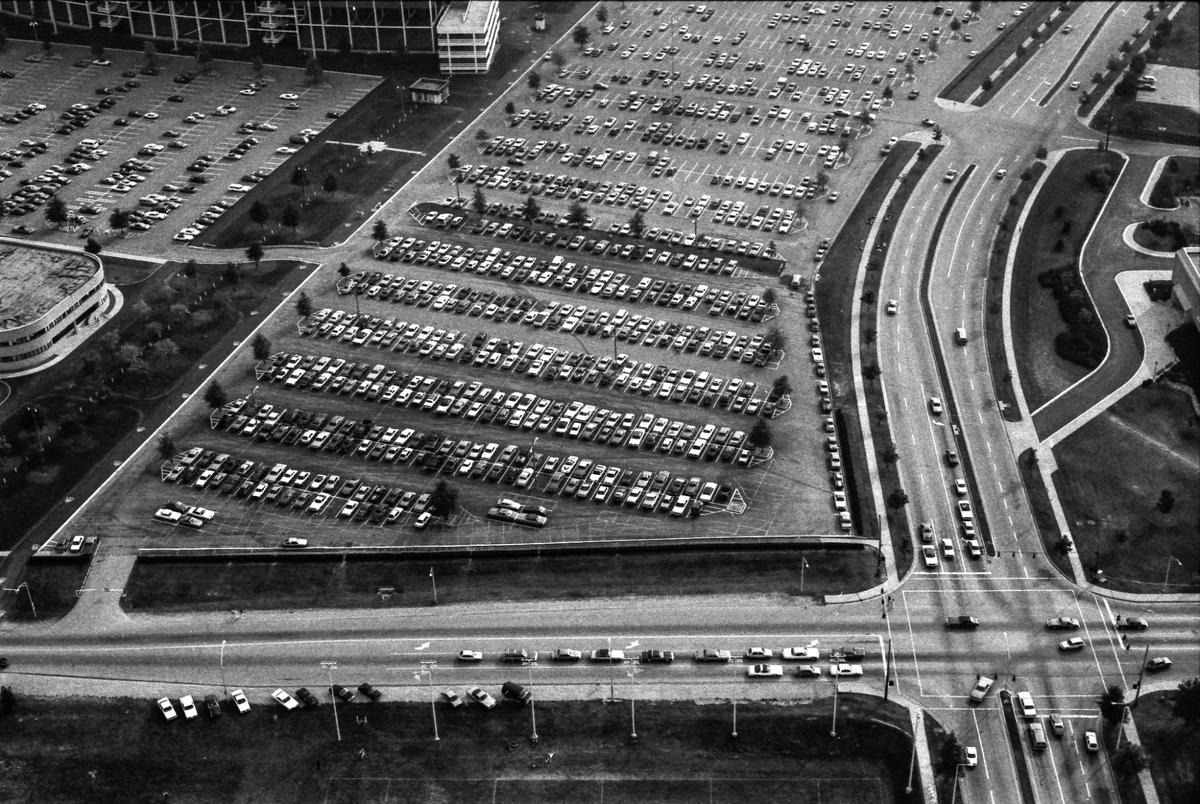 Cooper Drive, running from left to right across the bottom of this picture, intersects with University Drive on Oct. 4, 1982. The parking lot for what was then Commonwealth Stadium, the home field of the University of Kentucky football team is shown in the middle. One of the ramps to get to the upper decks of the stadium is visible at the top of the photo. The curved building at left is Lexington Technical Institute, today known as Bluegrass Community & Technical College. Note the cars parked right off Cooper Drive, facing the intramural fields.