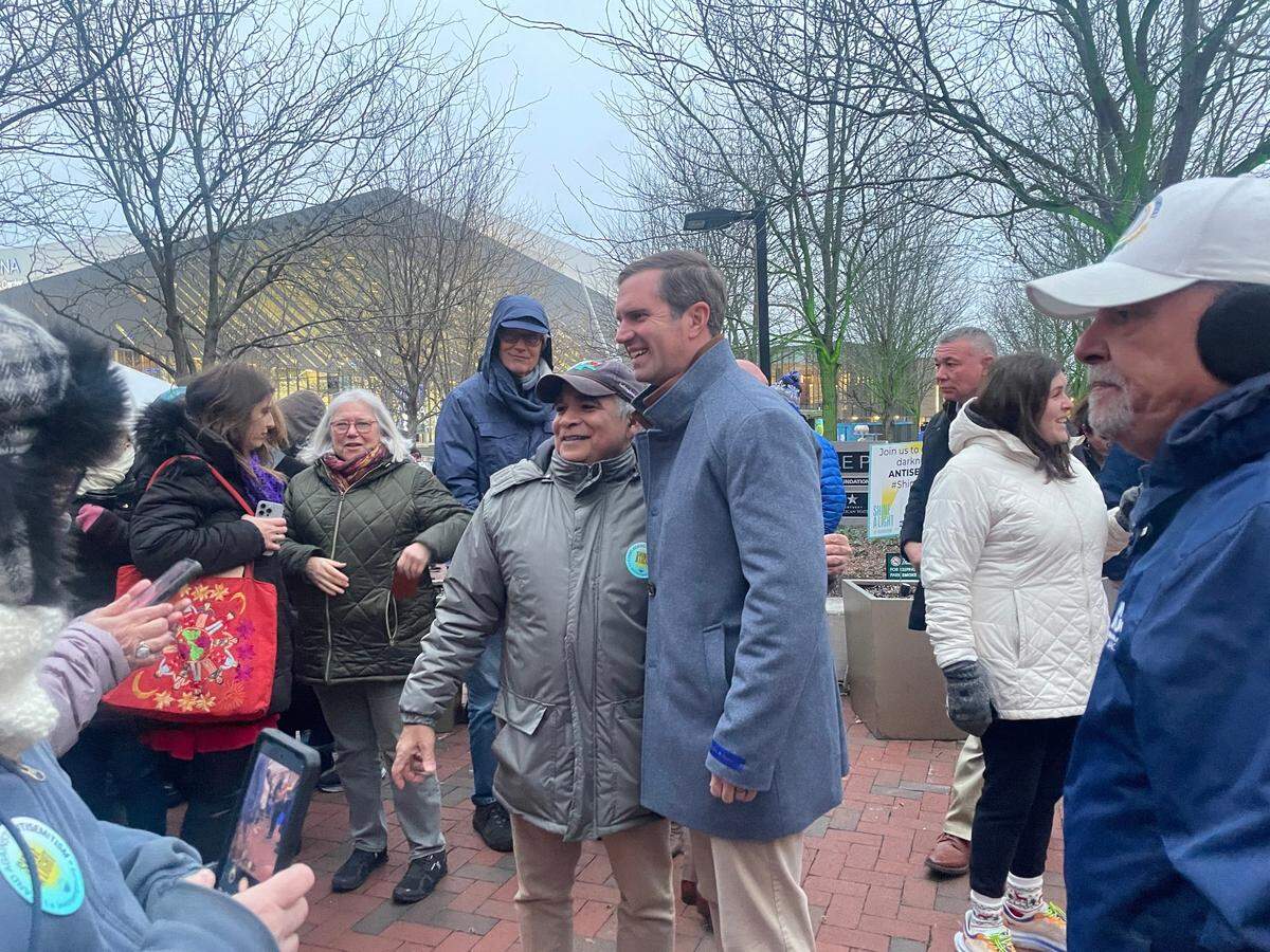 Governor Andy Beshear poses for a photo at Triangle Park.