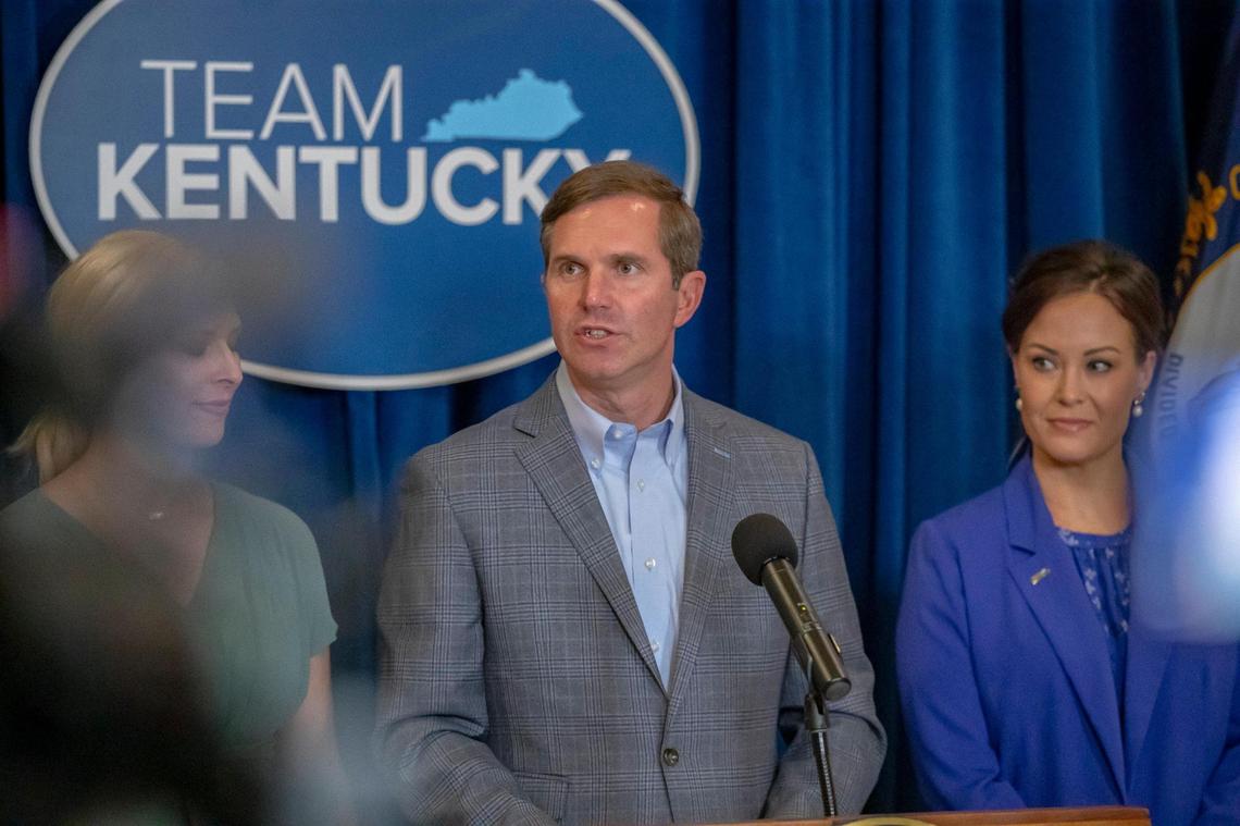 Kentucky Gov. Andy Beshear, with his wife, Britainy, left, and Lt. Gov. Jacqueline Coleman, speaks during a media conference at the Kentucky state Capitol in Frankfort, Ky., on Wednesday, Nov. 8, 2023, a day after he won reelection.