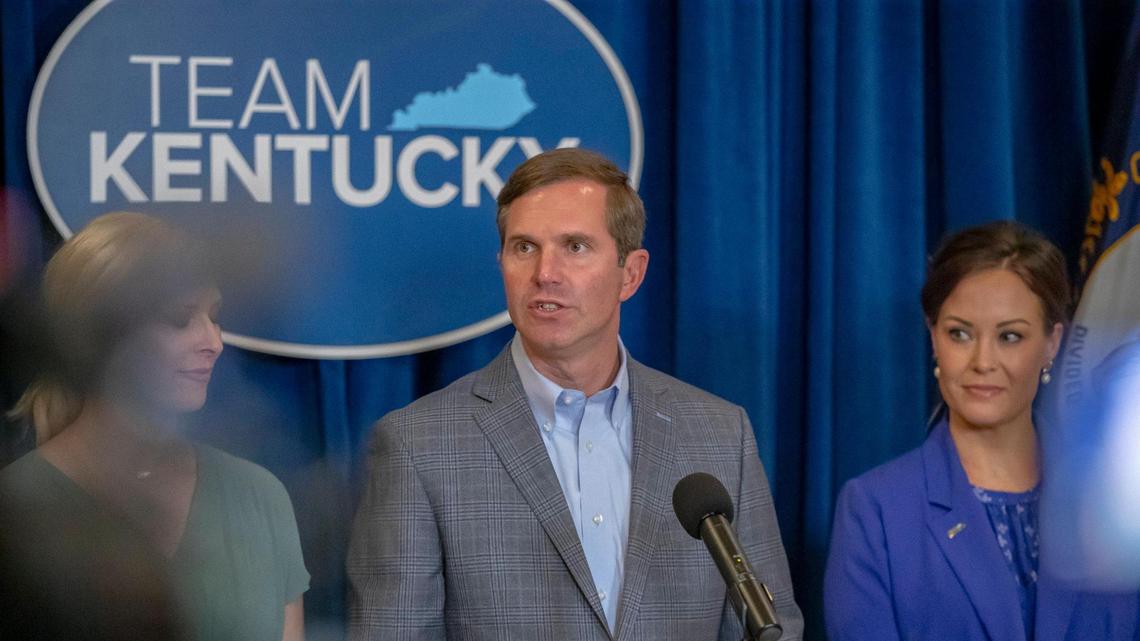 Kentucky Gov. Andy Beshear, with his wife, Britainy, left, and Lt. Gov. Jacqueline Coleman, speaks during a media conference at the Kentucky state Capitol in Frankfort, Ky., on Wednesday, Nov. 8, 2023, a day after he won reelection.