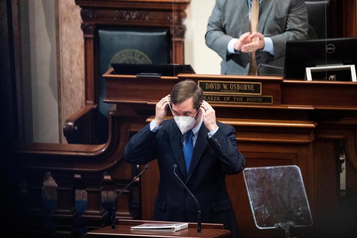 Gov. Andy Beshear replaces his mask after giving a State of the Commonwealth address Wednesday at the Capitol in Frankfort, Ky. Beshear talked about the pandemic, the multiple natural disasters that struck across the state and the economic development that also came to Kentucky in 2021.
