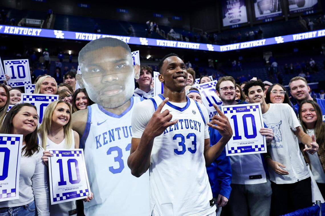 Kentucky’s Ugonna Onyenso (33) takes a photo with the student section after recording a Rupp Arena-record 10 blocks against Mississippi during Tuesday’s game.
