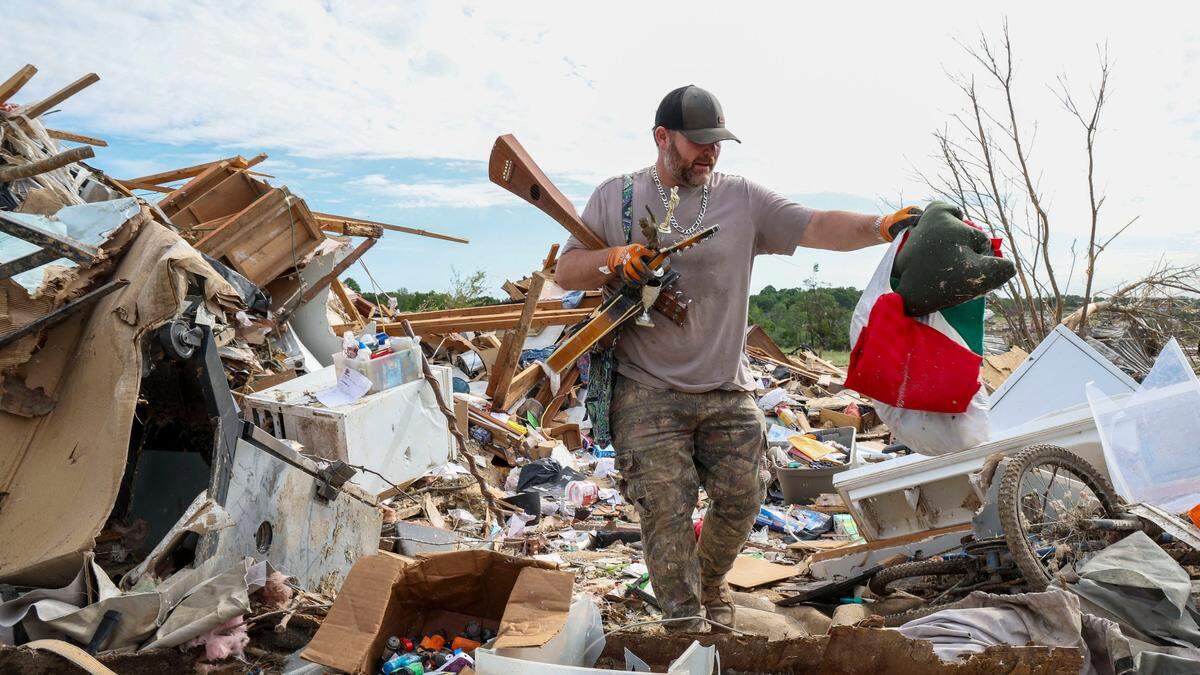 David Wilson takes items to be saved from his Sunshine Hills home, Sunday, May 18, 2025 in London, Ky. Wilson’s home was destroyed when a deadly tornado ripped through the neighborhood two days earlier. Wilson and his wife, Edwina, stayed in the home during the storm. “The walls just fell down around them,” Joe Wilson, their son said.