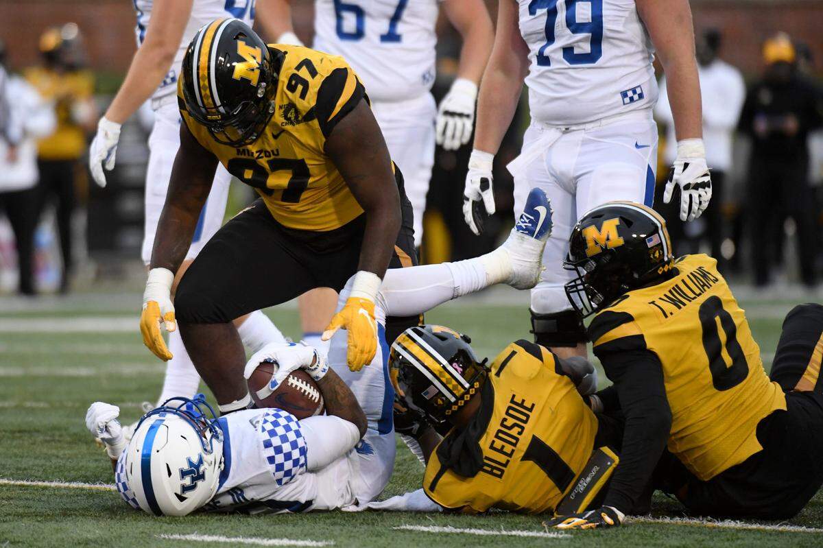 Missouri defender Akial Byers (97) stands over Kentucky running back A.J. Rose after a tackle in Mizzou’s 20-10 victory over UK last year in Columbia.