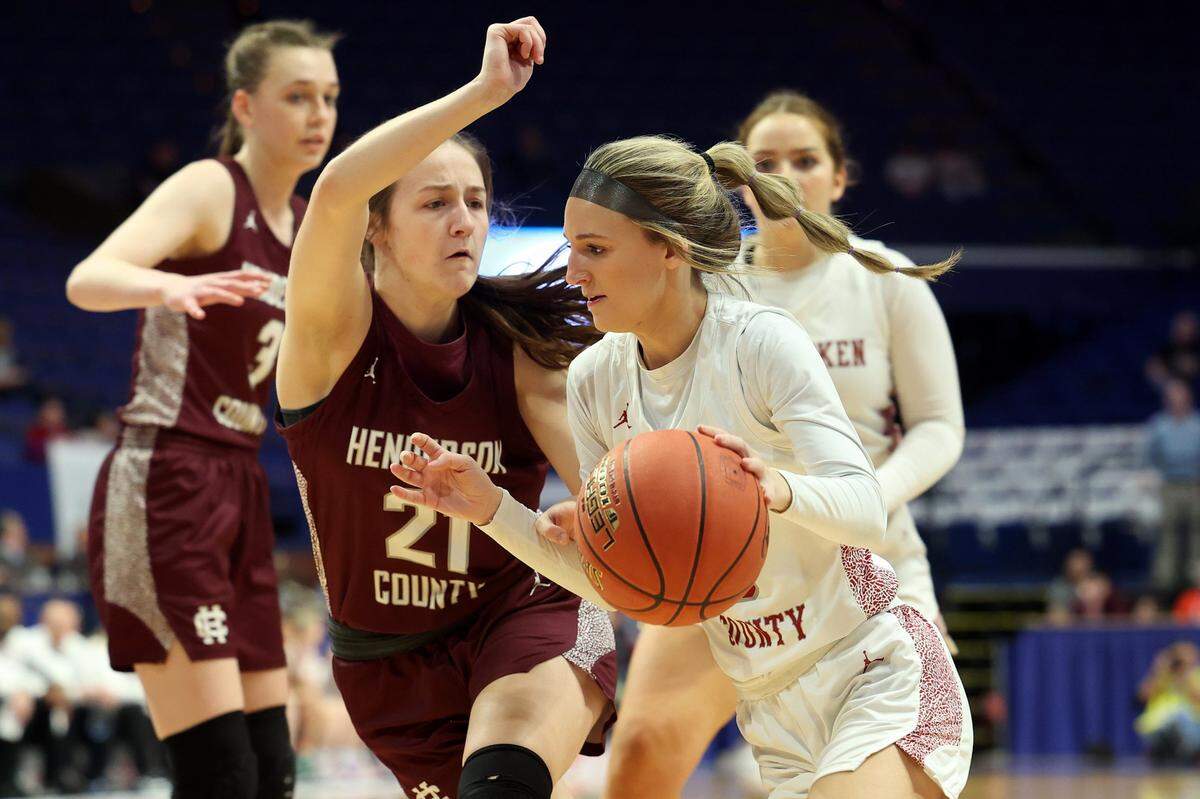 McCracken County’s Briley Benton, right, is defended by Henderson County’s Graci Risley (21) during their semifinal game in the Mingua Beef Jerky Girls’ Sweet 16 on Saturday.