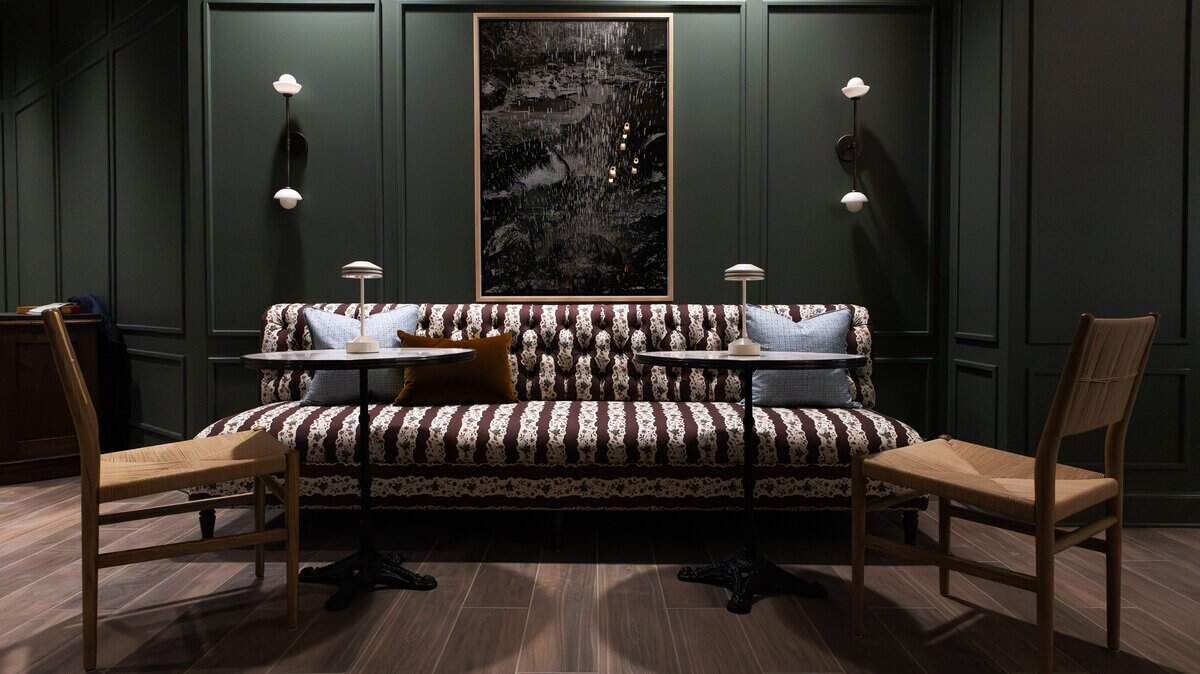 A posh sitting area with a classic tufted back, natural materials, and a stylish palette in the lounge area of the PNC Bank branch office, currently undergoing renovations at 325 West Main on May 20, 2026.