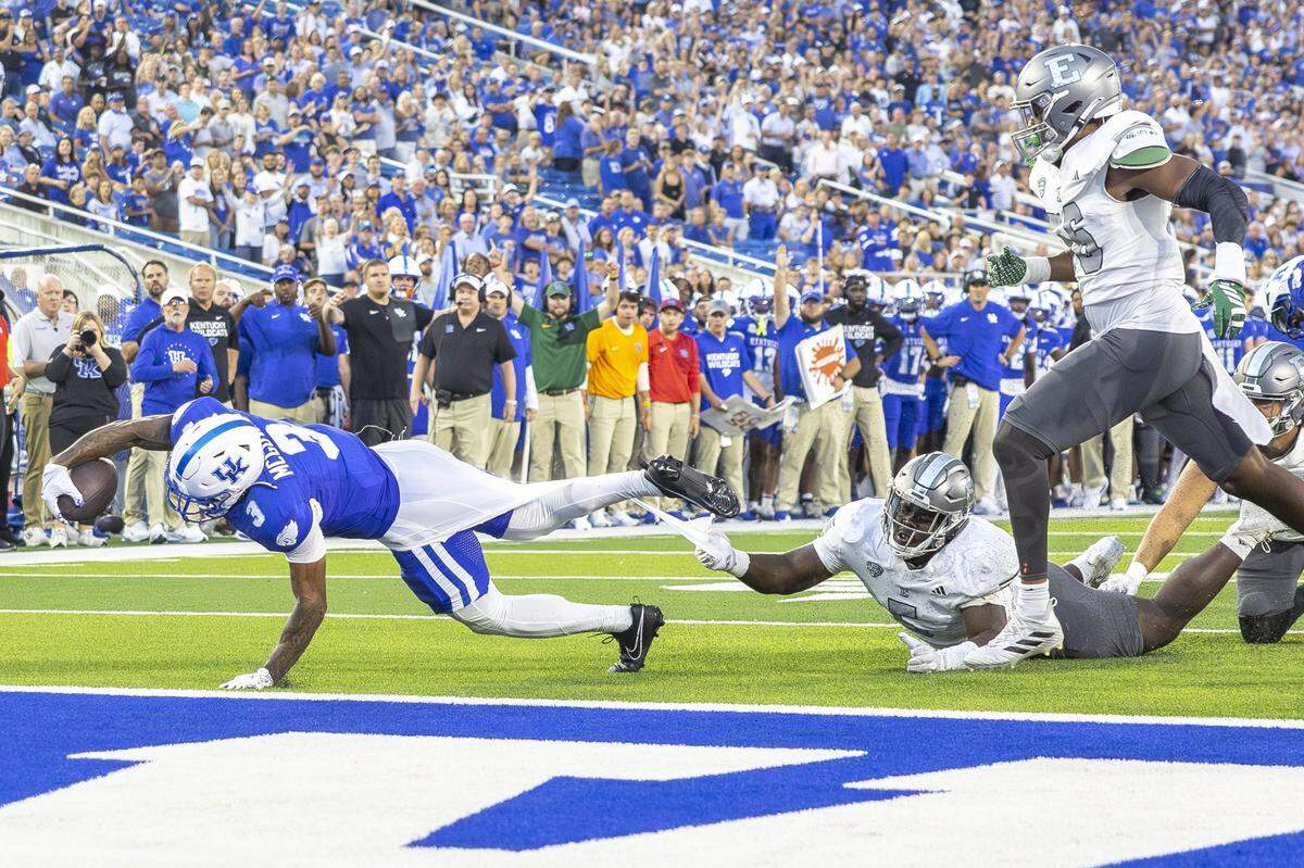 Kentucky running back Seth McGowan (3) reaches for a touchdown past Eastern Michigan’s Tyrell Martin during Saturday’s game at Kroger Field.