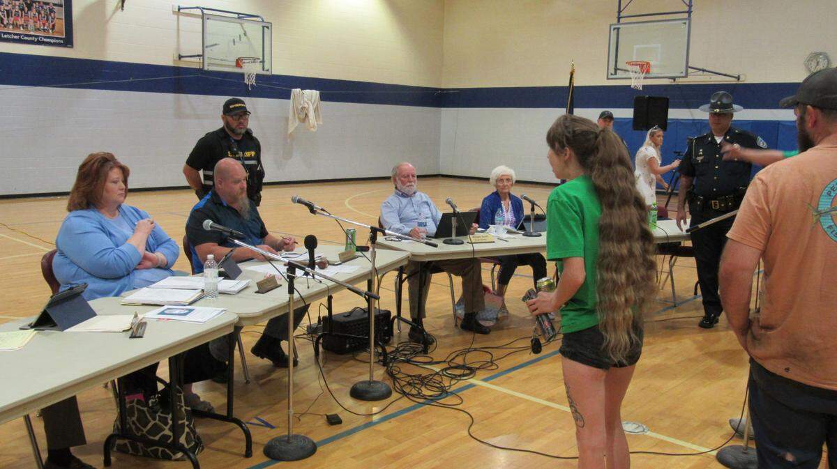 A woman criticizes members of the Letcher County Board of Education after they voted on April 28, 2025 to close Arlie Boggs Elementary School.