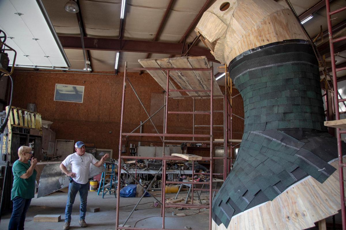 Keith Miller talks with Alice McIntosh at the shop where the head was rebuilt after collapsing last spring in Hazard, Ky., Friday, August 27, 2021.