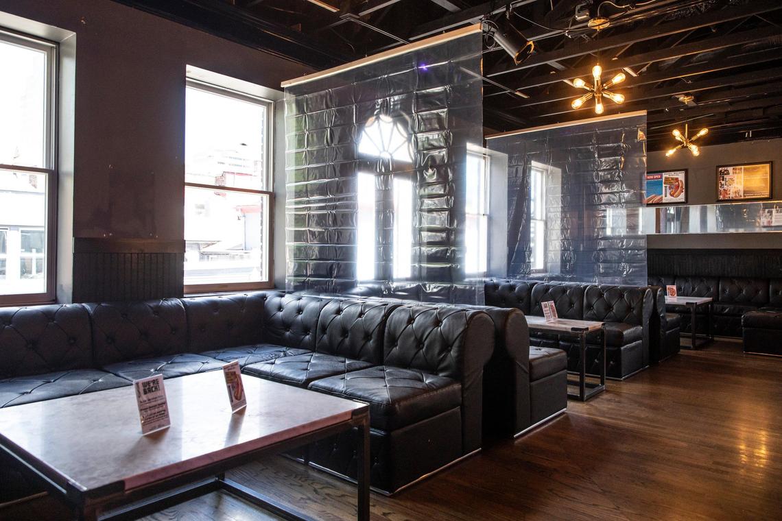 Plastic sheeting hangs Thursday between seating areas at Soundbar.