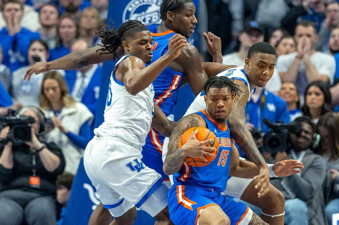 Kentucky’s Otega Oweh (00) and Brandon Garrison (10) defend Florida’s Alijah Martin during Saturday’s game at Rupp Arena.