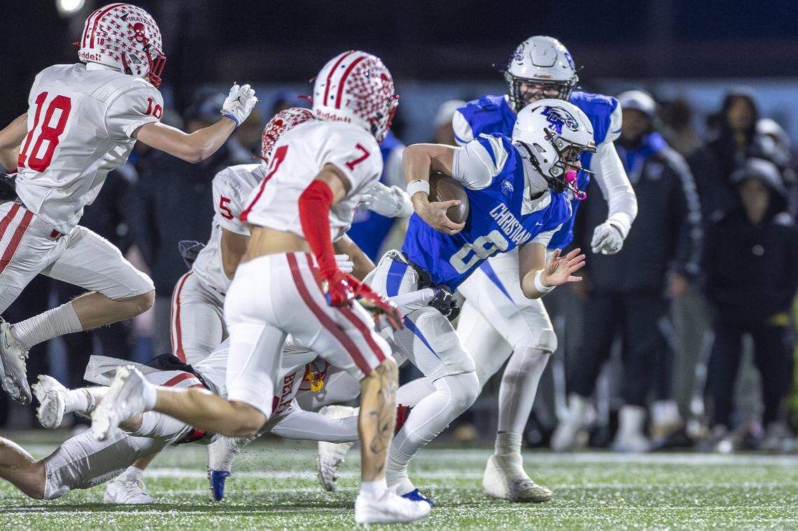 Lexington Christian's Nash Whelan (8) runs the ball past Belfry's Eli Caudill (7), Belfry's Dante Davis (5) and Belfry's Jameson Chaffin (18) during a game in Lexington, Ky., on Friday, Nov. 28, 2025.