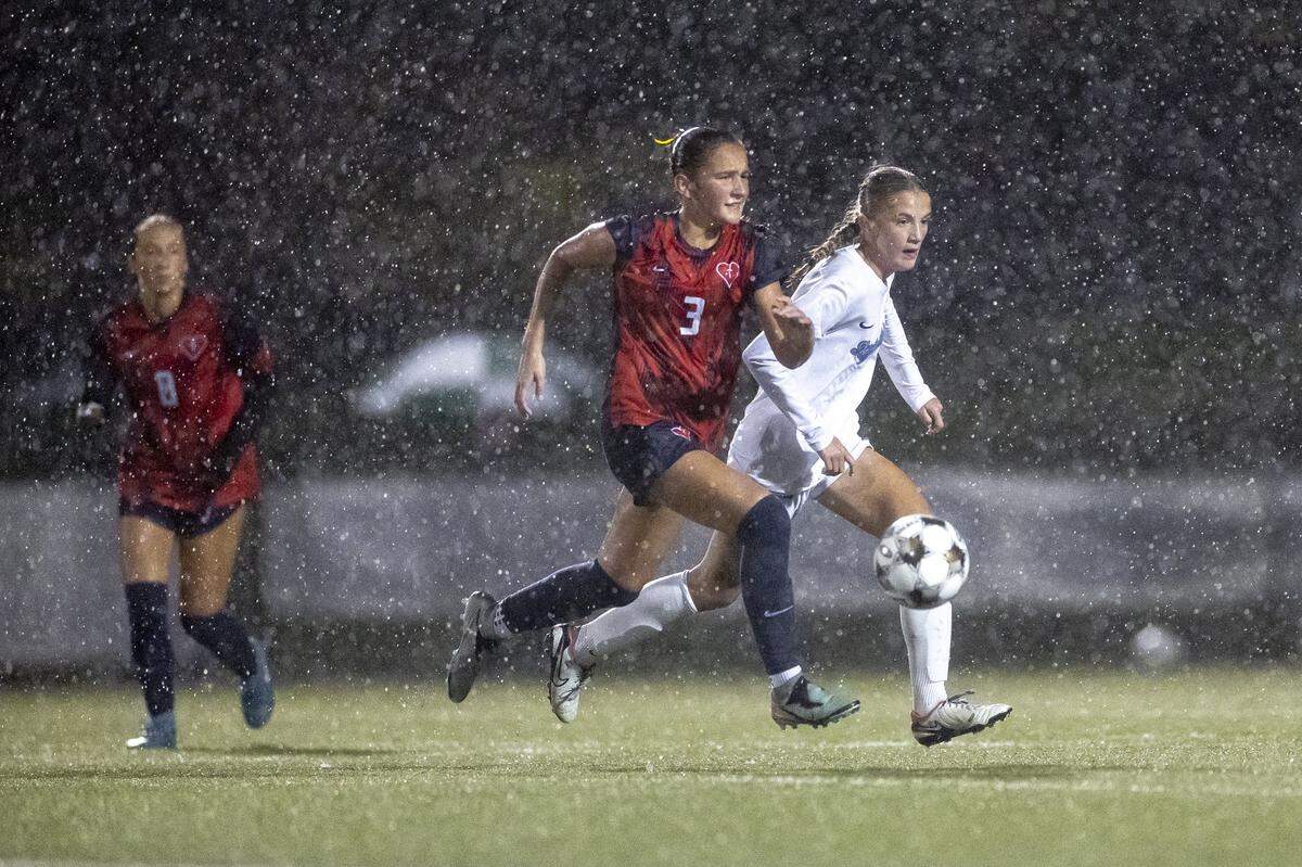Sacred Heat's Bella Holtgrave and Lexington Catholic's the ball during a game against Lexington Catholic in Lexington, Ky., on Wednesday, Oct. 29, 2025.