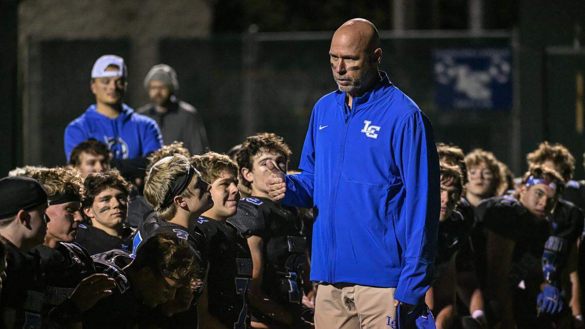 Lexington Catholic head coach, David Clark addresses his team after its 27-14 victory over Central in the second round of the Class 3A playoffs at Lexington Catholic High School on Friday.