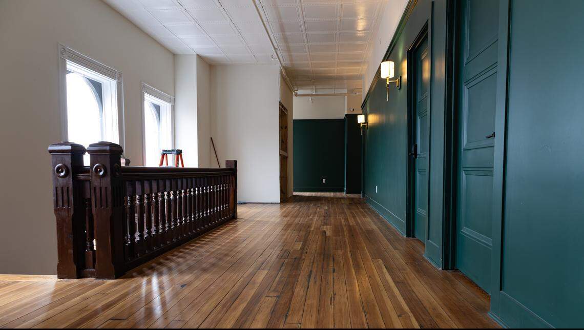Chocolate landings complement rich traditional hardwood floors, melting into a coving of Keeneland green hallways at Hotel Thoroughbred, a 19-room boutique hotel undergoing restoration in downtown Paris, Ky, on Dec. 4, 2025.