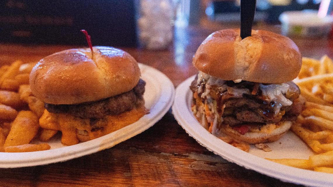 Southern Deli & Tavern’s The Winchester, left, and The Southern Burger. The Winchester features two beef patties, Kentucky Proud beer cheese, smoked bacon & beer battered fried onion. The Southern Burger has three quarter-pound patties of Kentucky Proud beef, BBQ sauce, sliced cheddar cheese, bacon, a beer battered onion ring, pimiento cheese and coleslaw.
