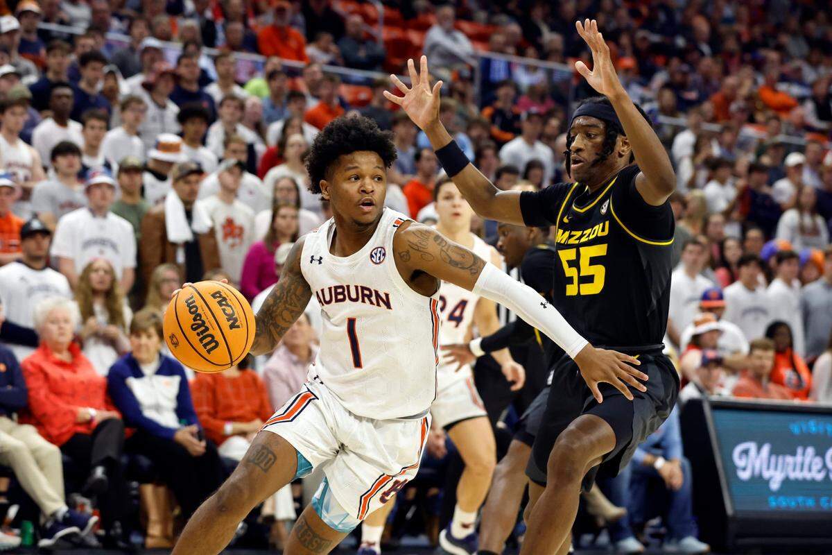 Auburn guard Wendell Green Jr. (1) drives to the basket around Missouri guard Sean East II (55) during the second half of an NCAA college basketball game, Tuesday, Feb. 14, 2023, in Auburn, Ala. (AP Photo/Butch Dill)