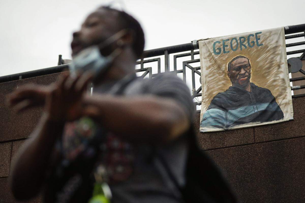 Jay Calhoun of Lexington speaks to other demonstrators under a George Floyd painting above the Lexington Transit Center during the seventh night of protests in downtown Lexington on Thursday, June 4, 2020. The protests come amid a nationwide outcry over the deaths of George Floyd in Minneapolis and Breonna Taylor in Louisville.