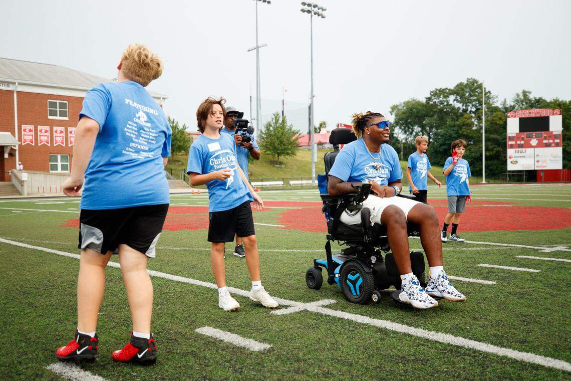 Chris Oats, right, watches warmups during the Chris Oats Football Camp on Saturday at Beechwood High School in Fort Mitchell. “He’s just been improving in all aspects, and it’s really good to see,” DeAndre Square said.