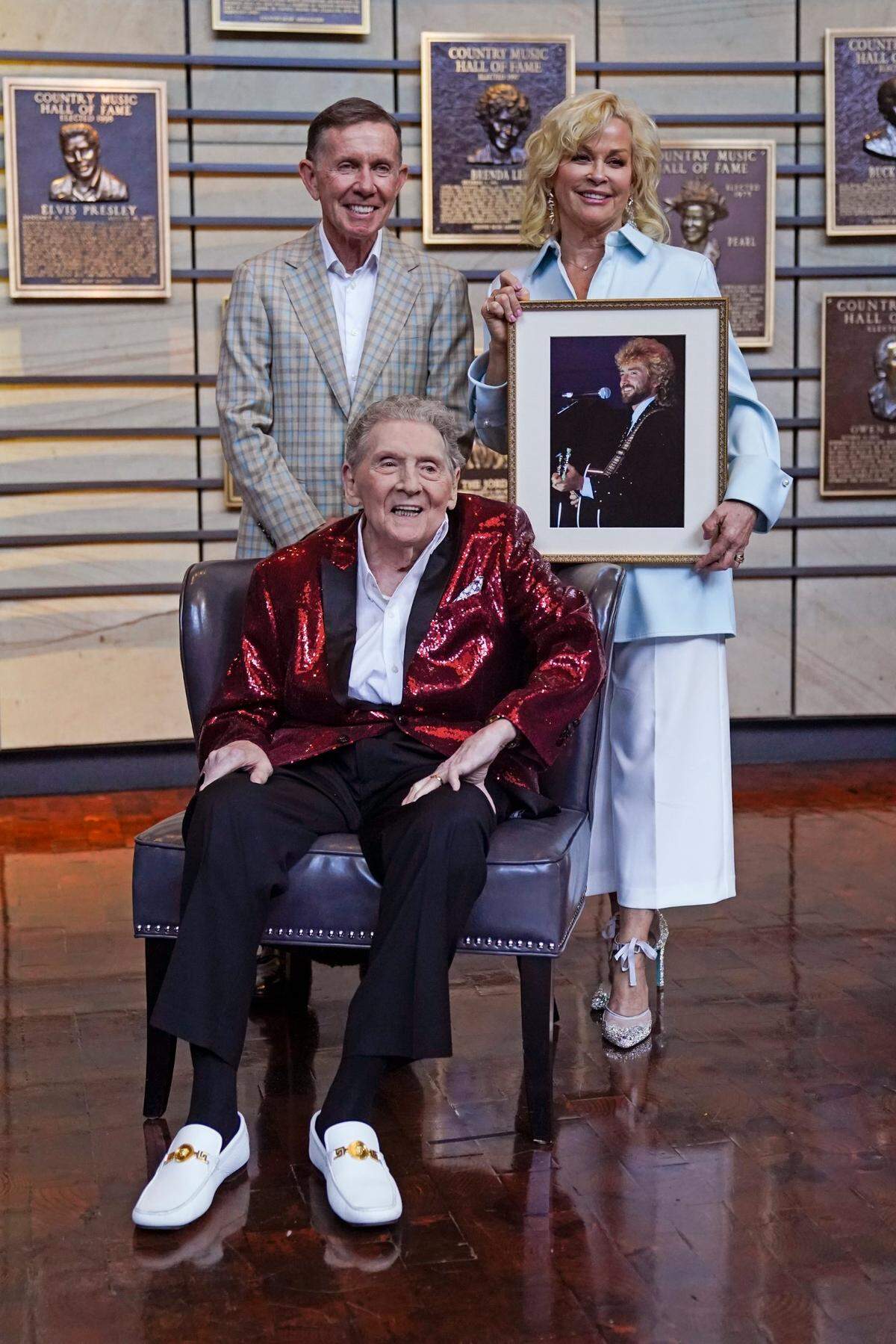 Music executive Joe Galante, left; singer Jerry Lee Lewis, center; and Lorrie Morgan, right, widow of country singer Keith Whitley; pose in the Country Music Hall of Fame Tuesday, May 17, 2022, in Nashville, Tenn. Galante, Lewis, and Whitley were announced Tuesday as the newest inductees. (AP Photo/Mark Humphrey)