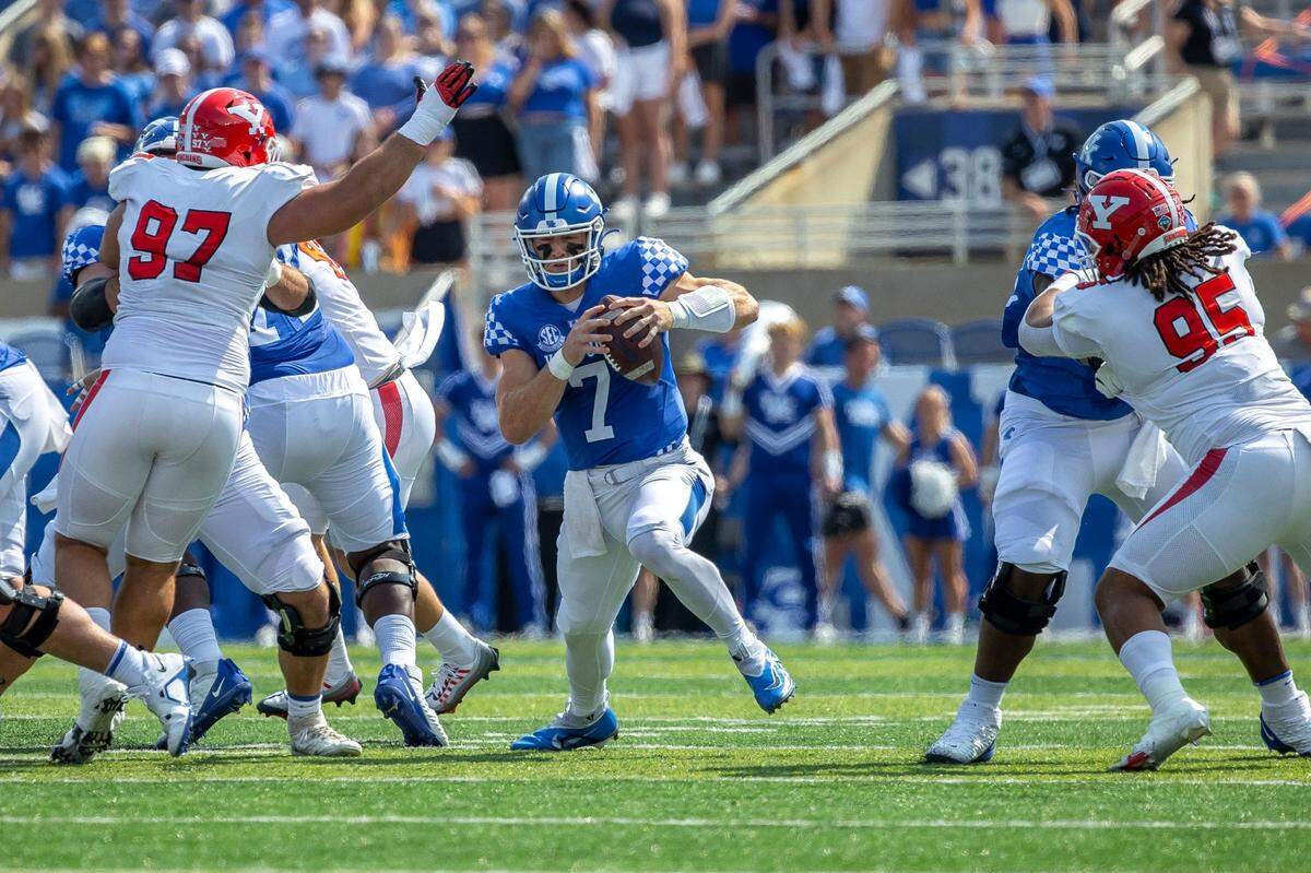 Kentucky quarterback Will Levis (7) faces pressure from Youngstown State defensive lineman Anthony Johnson (97) on Saturday at Kroger Field. Levis was sacked four times during the game.