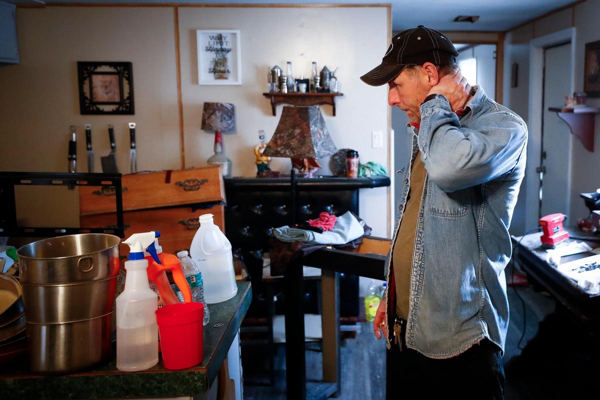 Anthony Seals, of Wallins Creek, Ky., looks over items in his trailer at Tremont trailer park in Wallins Creek, Thursday, Feb. 13, 2020. Seals arrived home after last week’s flood to find his trailer partially submerged and says he lost all of his possessions to water damage, “I was sick to my stomach just looking at it, knowing I’ve got to start over again,” he said.