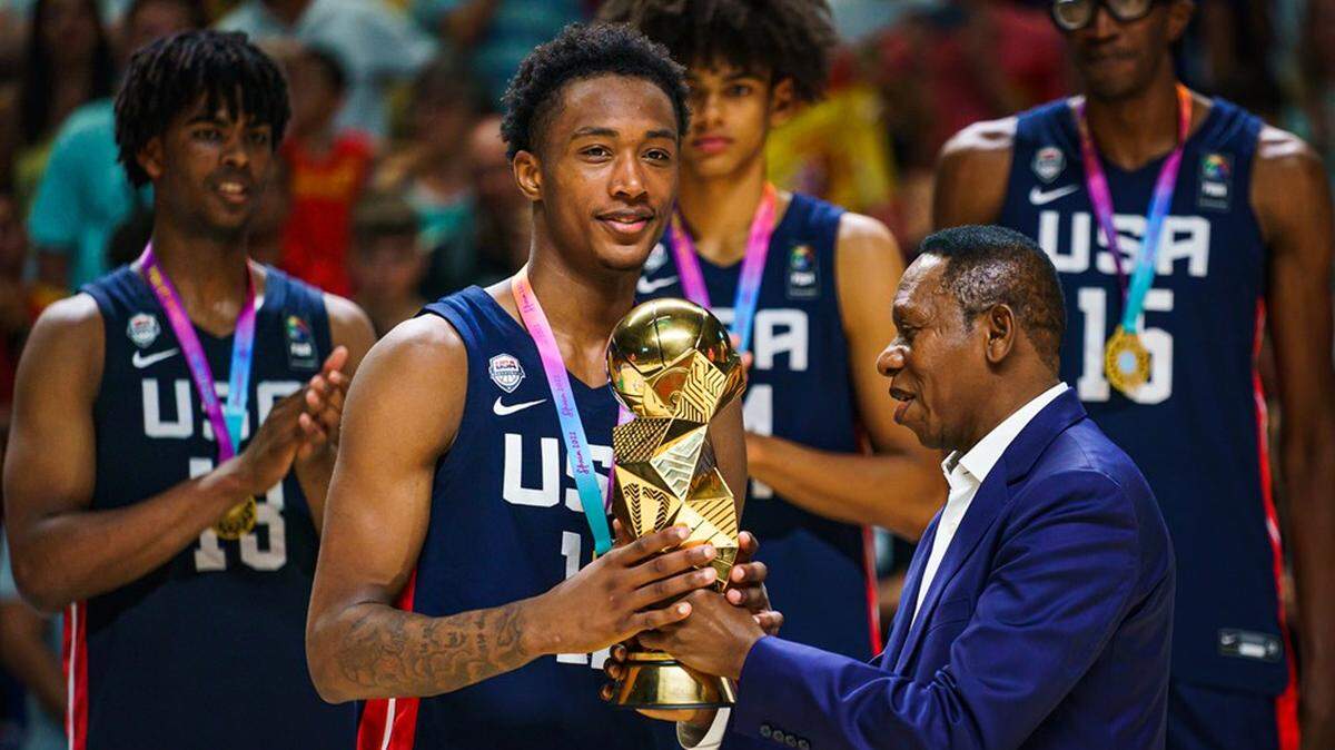 Ron Holland receives the FIBA U17 World Cup trophy after USA Basketball won the event Sunday.