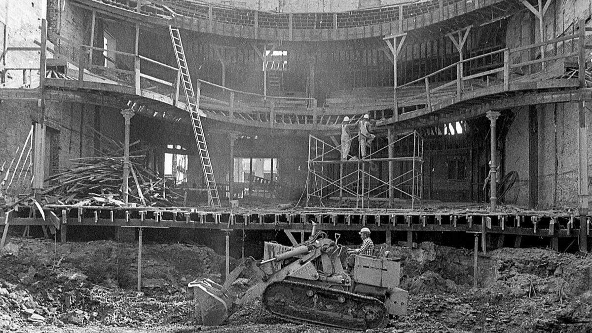 Don Williams rides a bulldozer Oct. 10, 1974 as the restoration of the Lexington Opera House continues in downtown Lexington. The historic theatre at the corner of West Short Street and South Broadway needed a renovation after high winds demolished the roof in 1973. Private and public fund drives started to save the theatre and ultimately it became part of the Lexington Center complex that included the new Rupp Arena and convention center that opened in 1976. Restoration of the 19th century structure cost $4 million. It reopened Friday, May 7, 1976 with a performance by the Lexington Philharmonic and the Lexington Singers.