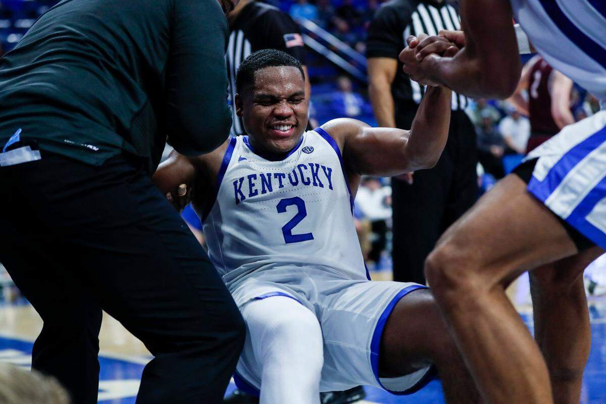 Kentucky’s Sahvir Wheeler is helped up after cramping during Tuesday night’s win over Bellarmine.