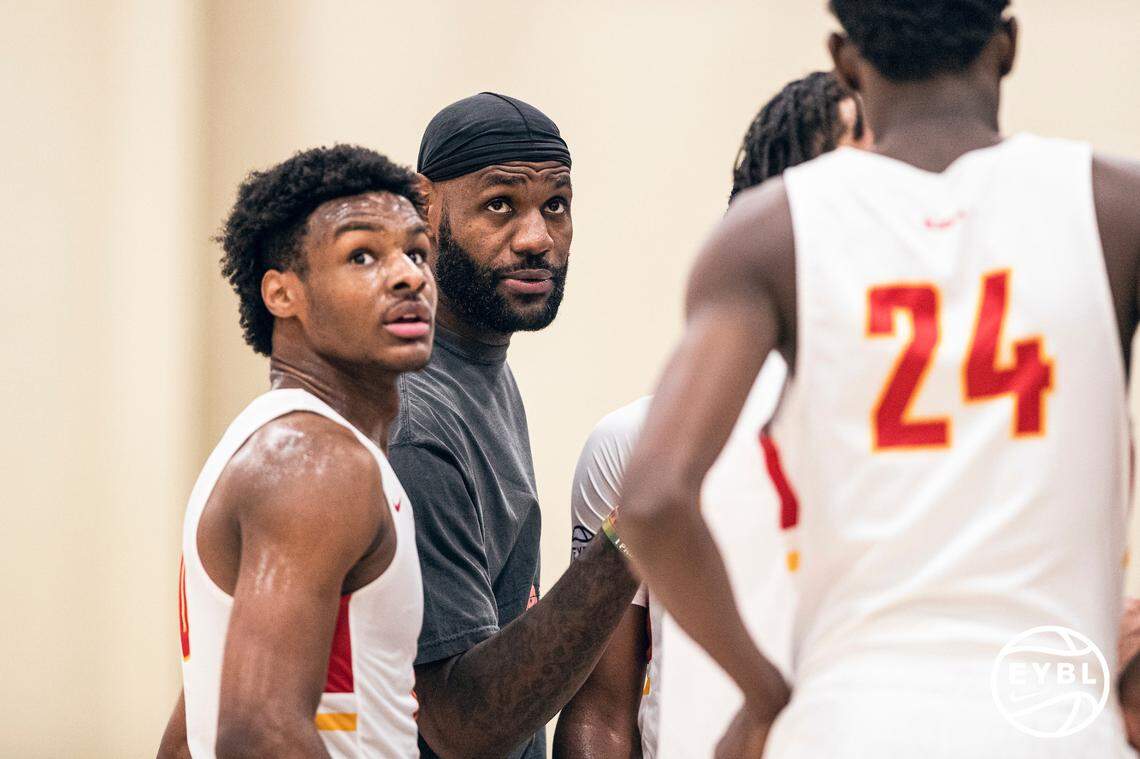 LeBron James talks with son Bronny James during a major Nike basketball event in July.