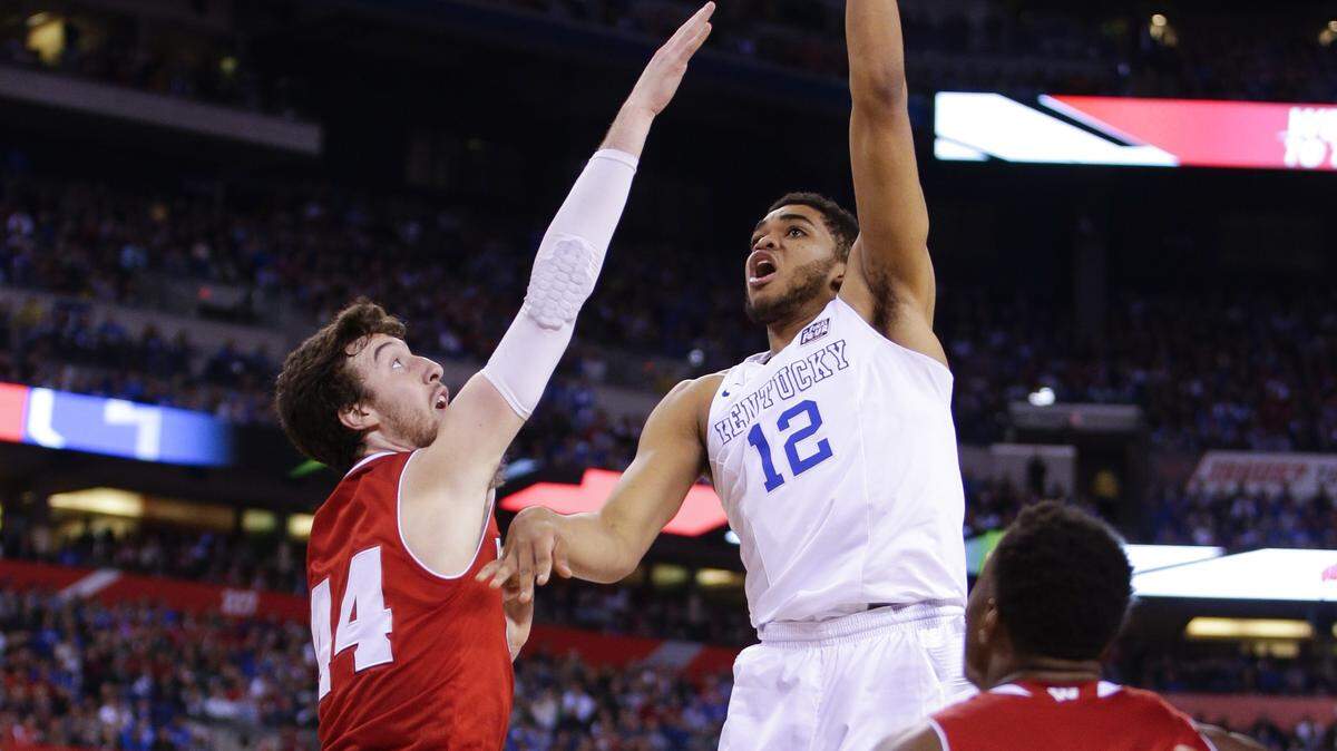 Kentucky Wildcats forward Karl-Anthony Towns (12) scored over Wisconsin Badgers forward Frank Kaminsky (44) as Wisconsin defeated Kentucky 71-64  in the NCAA Final Four on Saturday April 4, 2015 in Indianapolis, IN. Photo by Mark Cornelison | Staff







