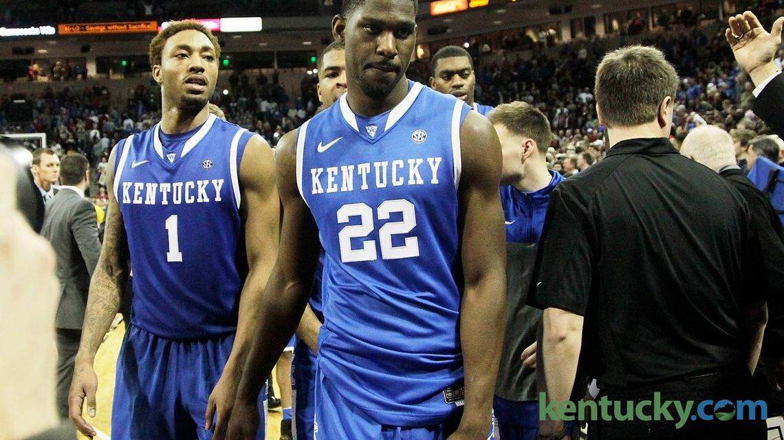 Kentucky basketball players James Young, left, and Alex Poythress left the court as South Carolina fans rushed the court after the Gamecocks beat the Cats, 67-72, on Saturday.