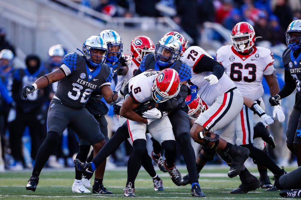 Georgia Bulldogs running back Kenny McIntosh (6) is tackled by Kentucky Wildcats linebacker J.J. Weaver (13) during the game at Kroger Field in Lexington, Ky., Saturday, November 19, 2022.
