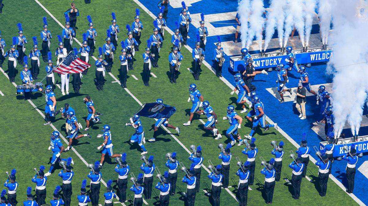 The Kentucky Wildcats and head coach Mark Stoops run onto the field for their football game against South Carolina on Sept. 7, 2024, at Kroger Field.