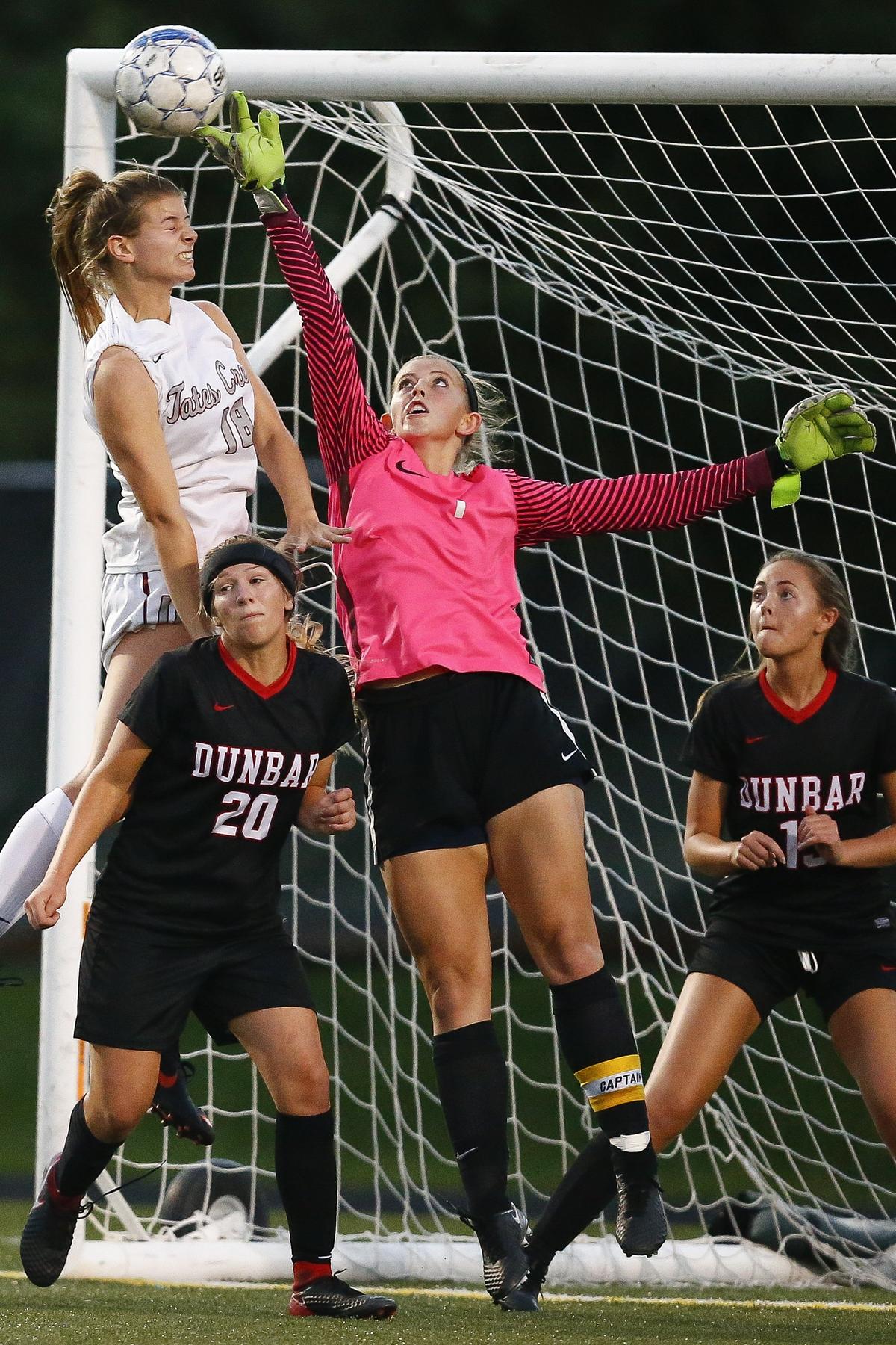 Paul Laurence Dunbar’s Morgan Turcotte (1) blocked a corner kick and an attempted goal from Tates Creek’s McKensey Bunch (18) during the 43rd District girls soccer semifinal Tuesday at Paul Laurence Dunbar High School in Lexington. Paul Laurence Dunbar beat Tates Creek 3-2 on penalty kicks.