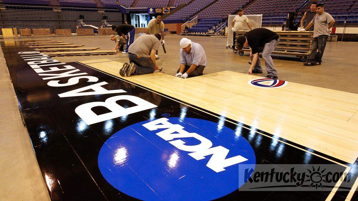 A crew put down the NCAA basketball floor in Rupp Arena in Lexington., Ky., Monday, March 18, 2013. The floor was sent to Rupp Arena by the NCAA for rounds 2 and 3 of the tournament which will be played in Rupp on Thursday and Saturday. Photo by Charles Bertram | Staff





