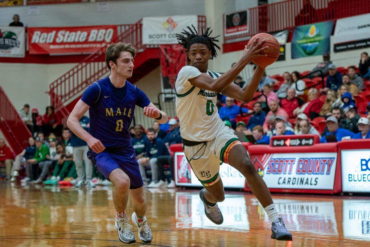 Great Crossing’s LJ Holman (0) drove as Male’s Cole Edelen (0) defended at Scott County High School in the Dan Cummins Classic on Jan. 20.