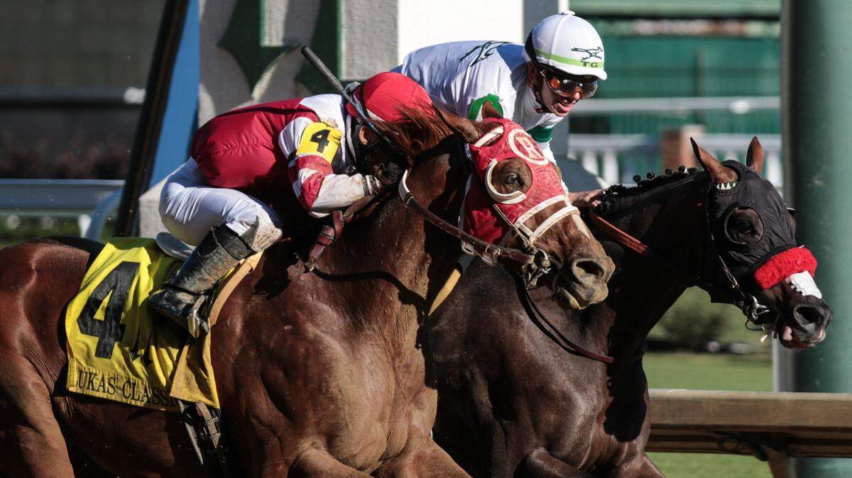 Tyler Gaffalione, aboard Hot Rod Charlie, and Sonny Leon, riding Rich Strike (4) battled to the finish of Saturday’s Lukas Classic Stakes at Churchill Downs in Louisville. Hot Rod Charlie won the race in a photo finish.