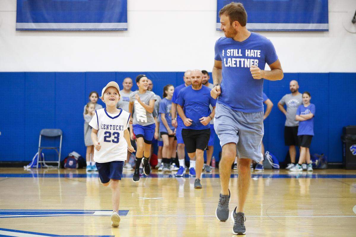 Phoebe Tong, 9, of Owensboro warms up with her father Jordan Tong, also of Owensboro, during The inaugural John Calipari Father/Daughter Camp at the Joe Craft Center in Lexington, Ky., Saturday, June 22, 2019.
