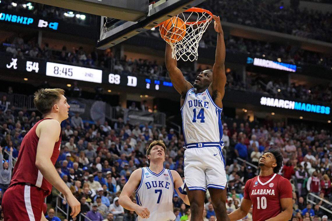 Duke guard Sion James (14) dunks ball against Alabama forward Mouhamed Dioubate (10) during the second half in the East Regional finals on March 29 in Newark, New Jersey.