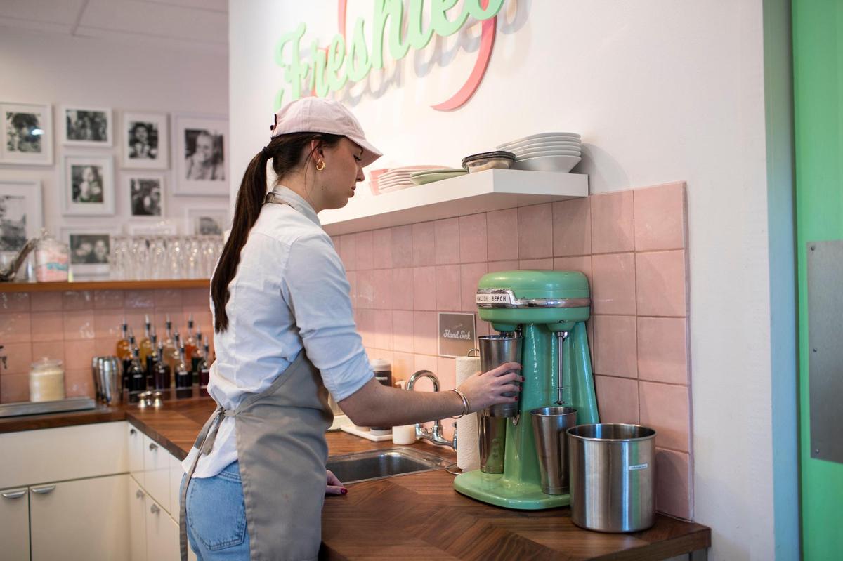 Ella Martin handspins a cotton candy shake for a customer at Freshie’s Ice Cream & Soda Fountain in Lexington, Ky., Wednesday, November 30, 2022.