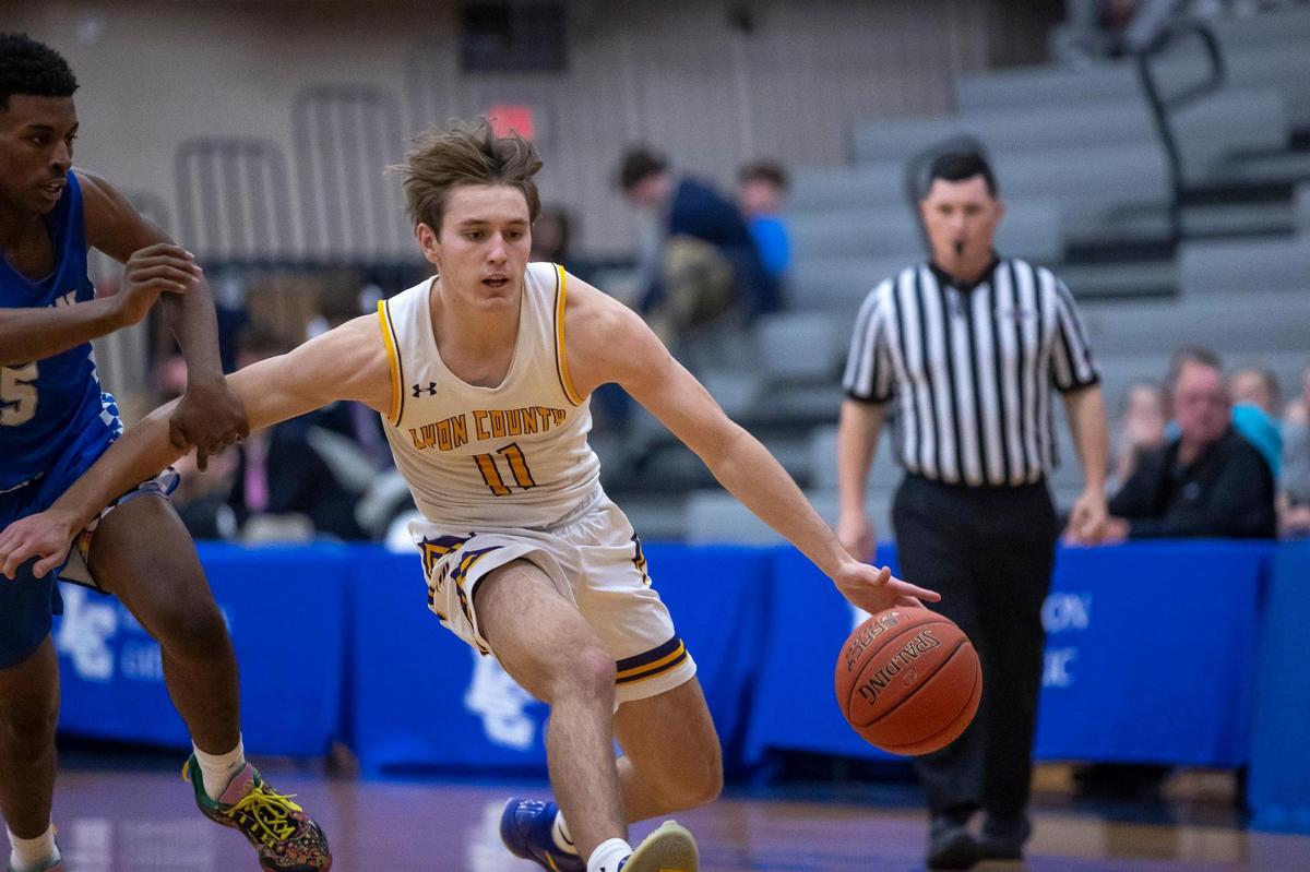 Lyon County’s Travis Perry (11) drives against Mason County’s Khristian Walton (5) during Friday’s third-place game in the White, Greer & Maggard Holiday Classic at Lexington Catholic High School on Friday. Perry scored 31 points in the Lyons’ 92-85 double-overtime victory.