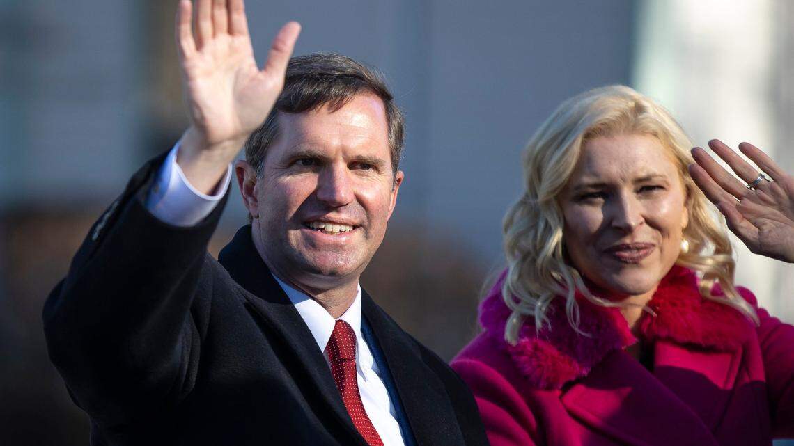 Kentucky Gov. Andy Beshear and his wife, Britainy Beshear, wave to supporters during the Inaugural Parade along Capital Avenue in Frankfort, Ky., on Tuesday, Dec. 12, 2023.  