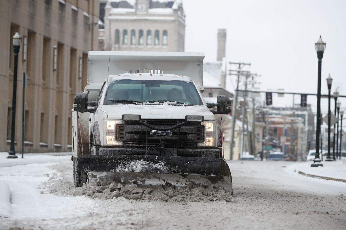 A Lexington city plow truck on Short Street works to clear the street of snow Friday, Jan. 7, 2022.